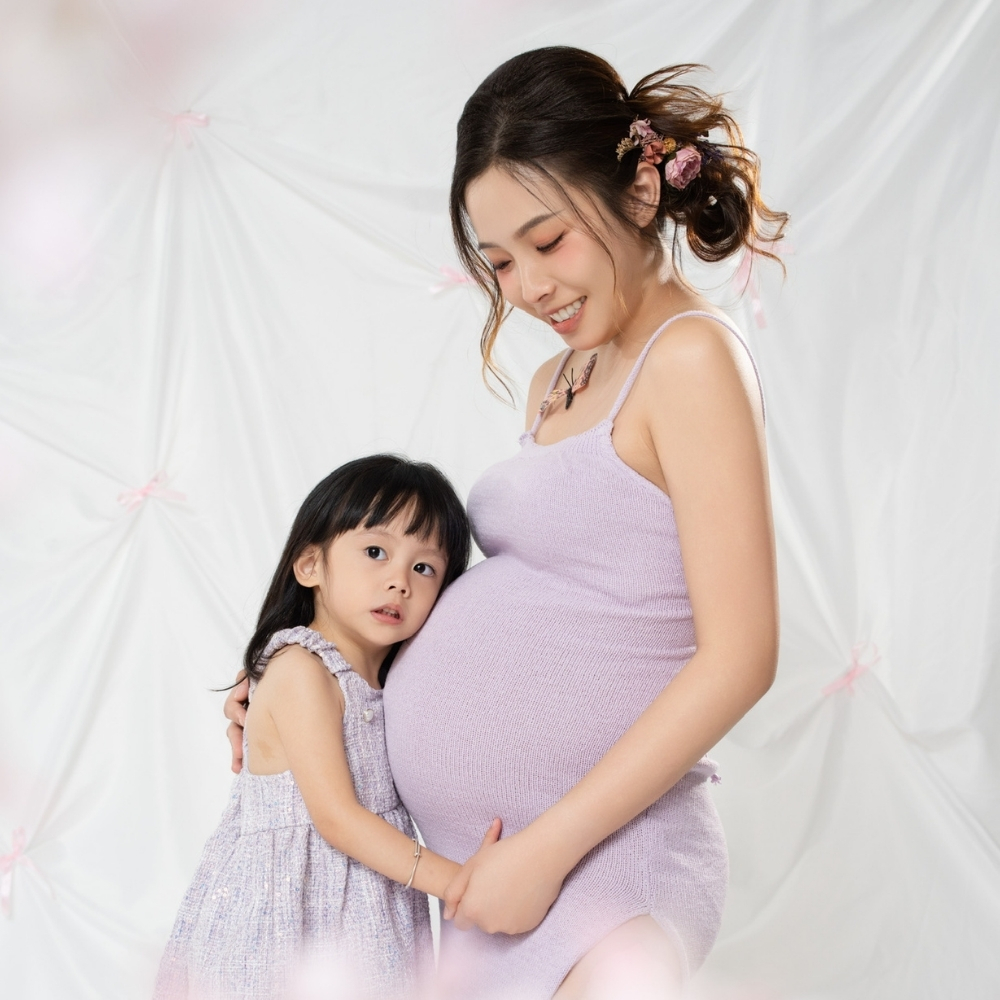 Pregnant mother with her child